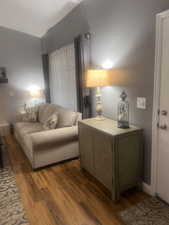 Living area with wood finished floors and baseboards