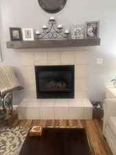 Detailed view of wood finished floors and a fireplace