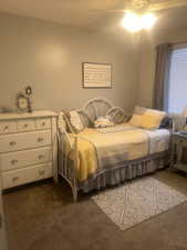 Bedroom featuring dark carpet and ceiling fan