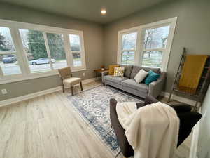 Living room featuring light wood finished floors and recessed lighting