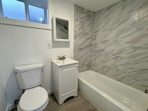Full bathroom featuring vanity, light wood-style flooring, and tub / shower combination
