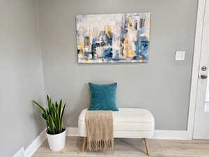Sitting room with baseboards and wood finished floors