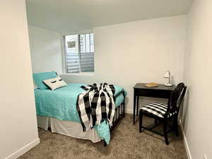 Bedroom featuring carpet floors and baseboards