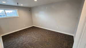 Empty room with baseboards and recessed lighting
