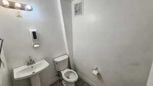 Bathroom featuring toilet and baseboards