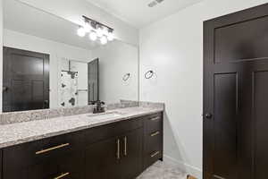 Full bath featuring vanity and a shower