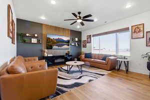 Living area featuring a ceiling fan, wood finished floors, and recessed lighting