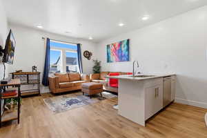 Living room featuring light wood-style floors and recessed lighting