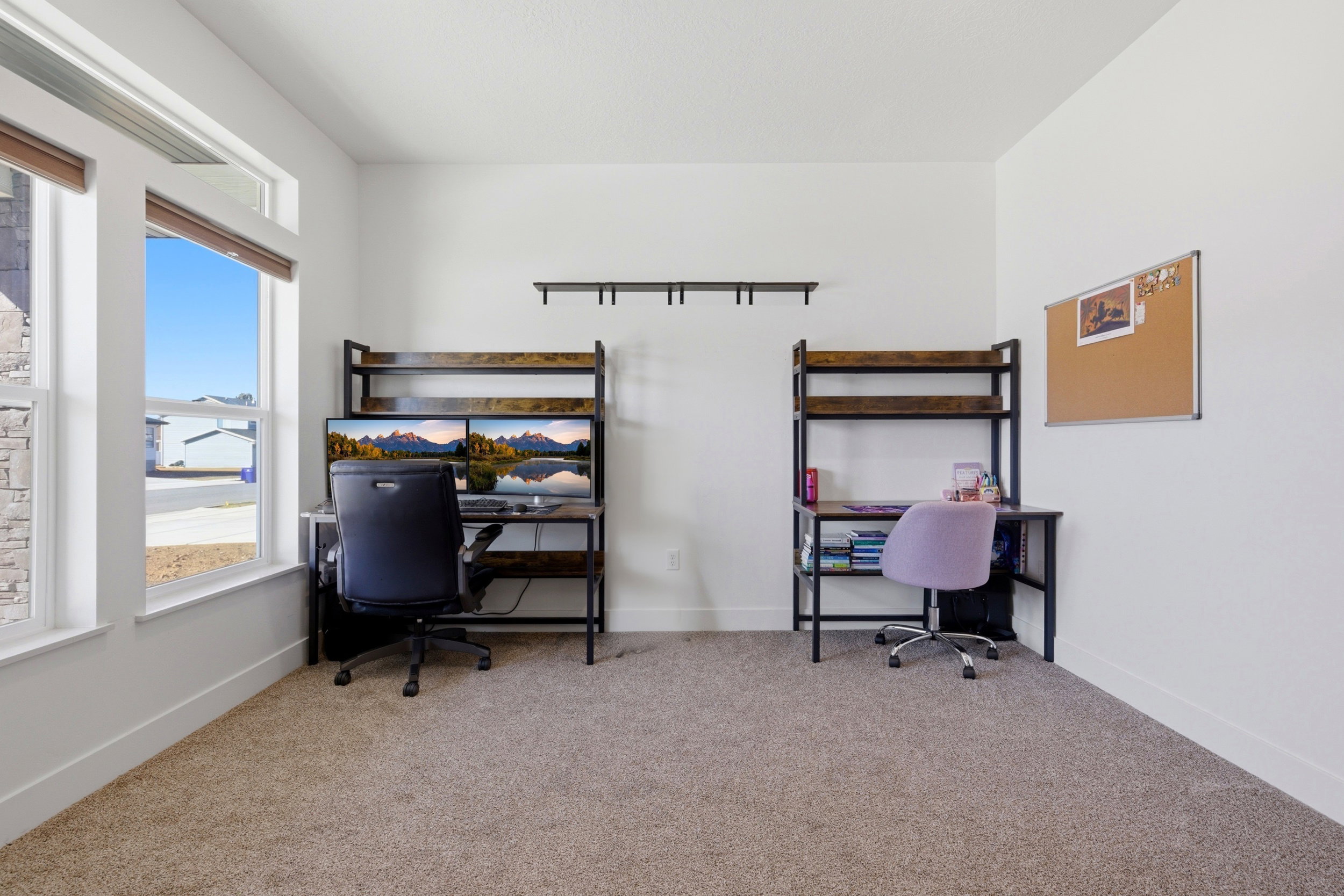 Bedroom with a desk and light carpet