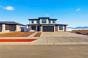 Prairie-style house with concrete driveway and a garage