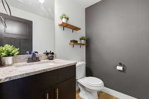 Half bath with vanity and light wood-type flooring