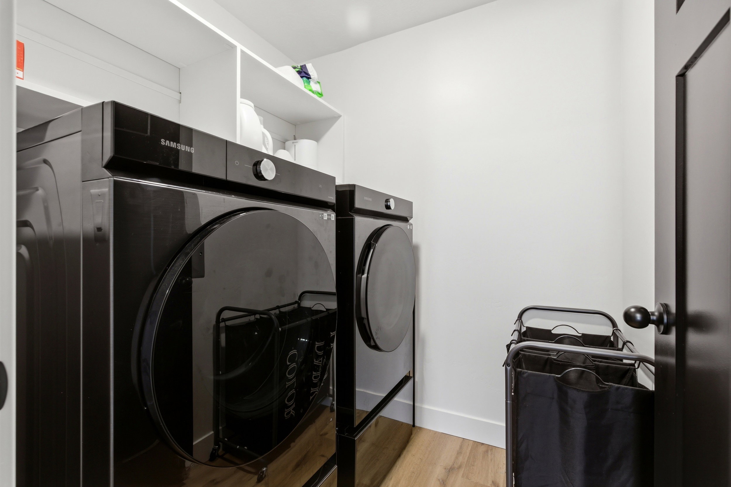 Laundry area featuring washer and clothes dryer and light wood-type flooring