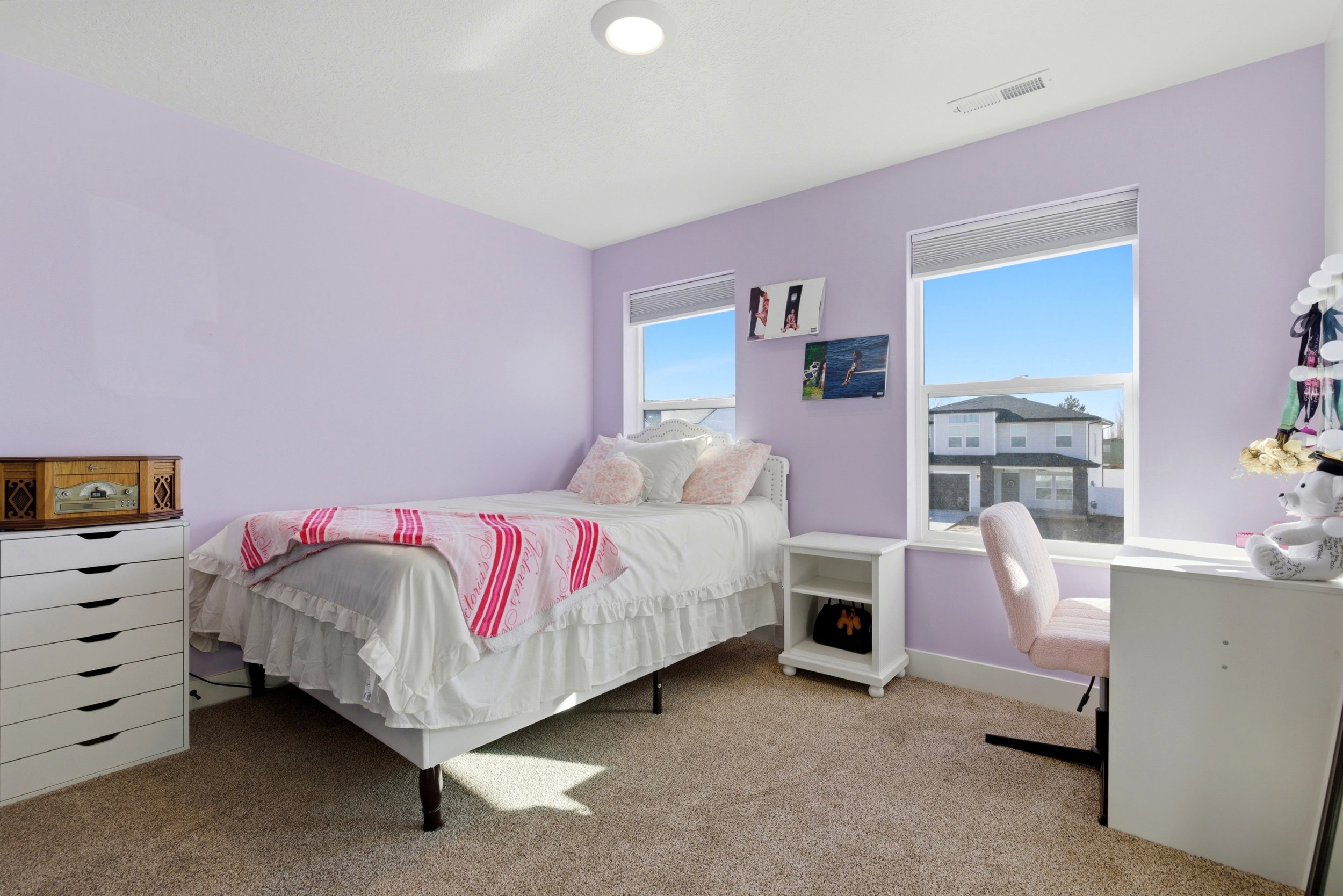 Bedroom featuring light carpet and baseboards