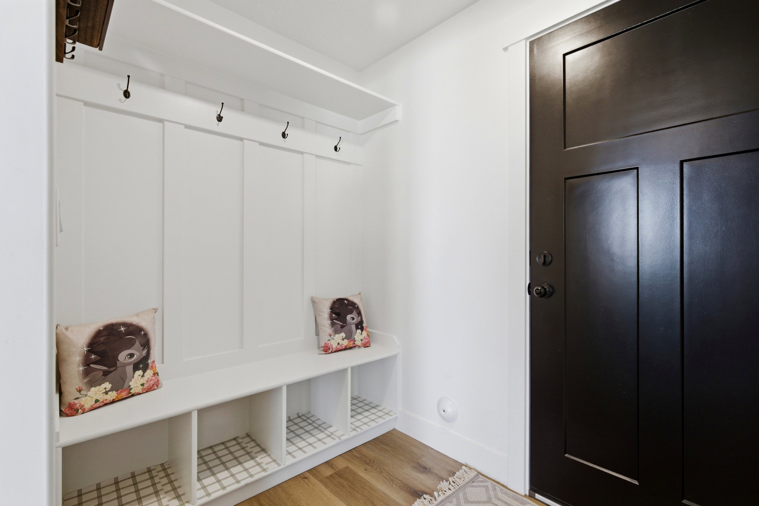 Mudroom featuring light wood-style floors and baseboards