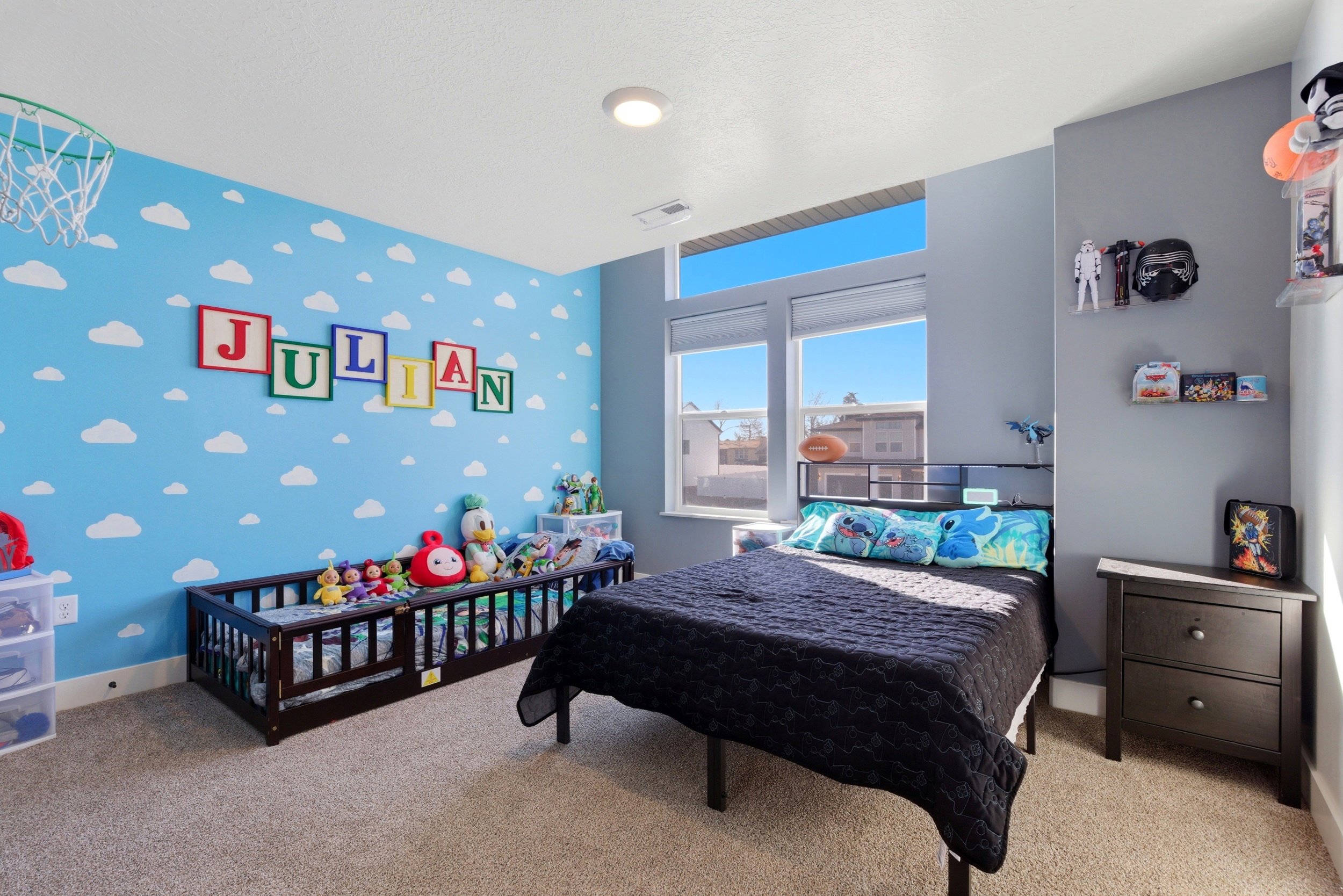 Bedroom with an accent wall, carpet flooring, and wallpapered walls