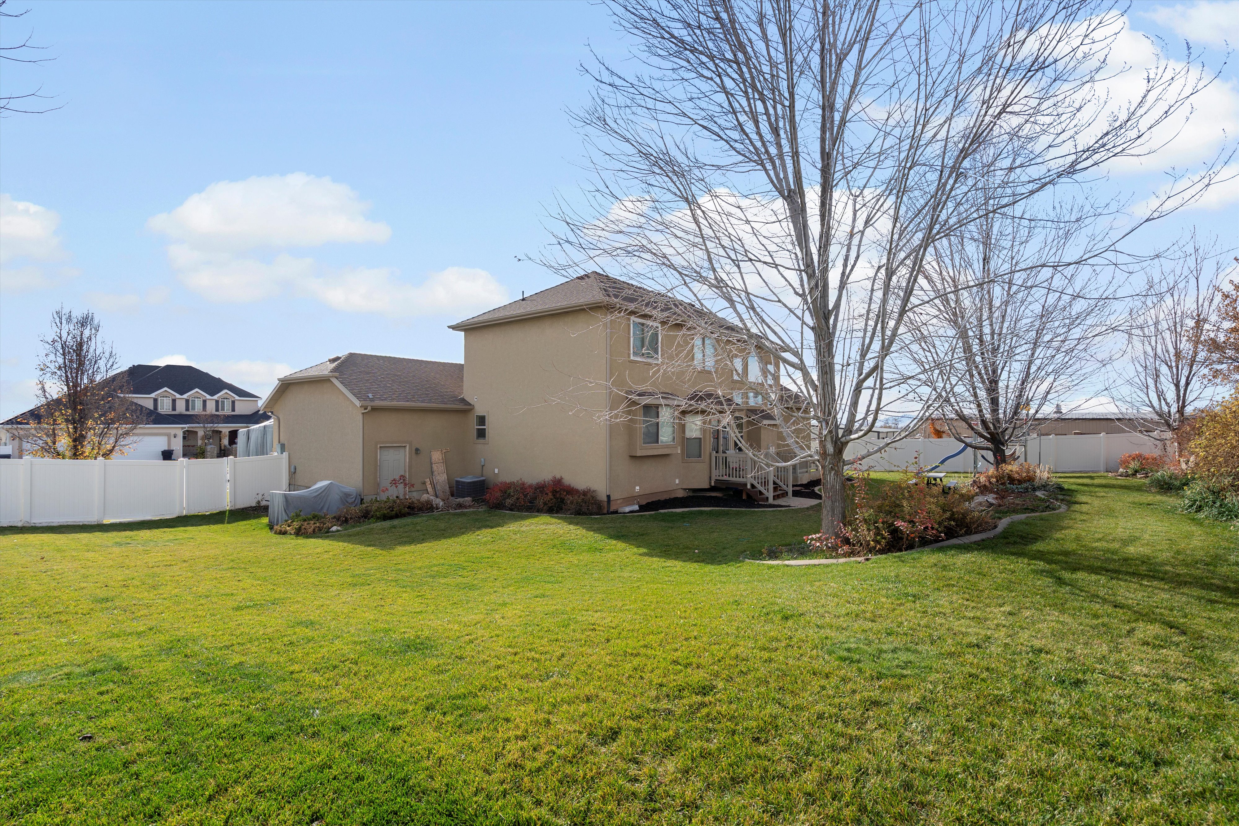 Rear view of property with stucco siding