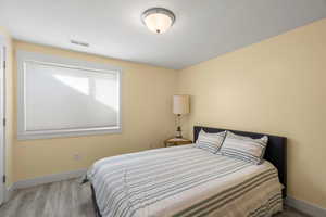 Bedroom featuring baseboards and wood finished floors