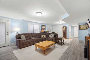 Living room with light wood-style flooring and a textured ceiling