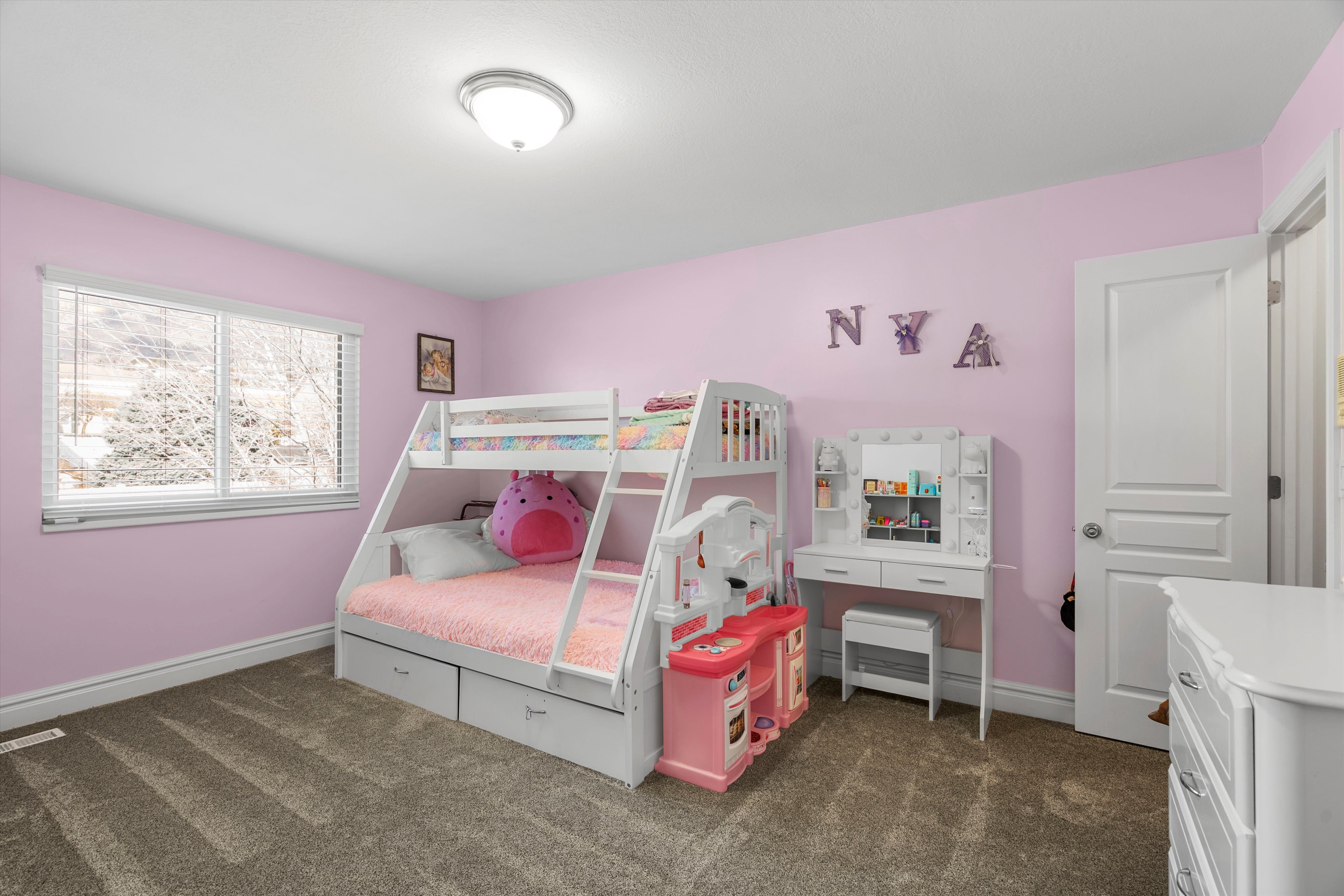 Bedroom with dark carpet and baseboards