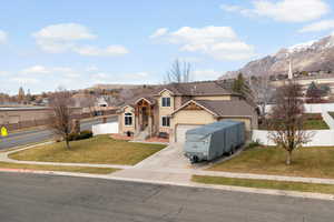 Traditional-style home with driveway, a mountain view, a residential view, and an attached garage