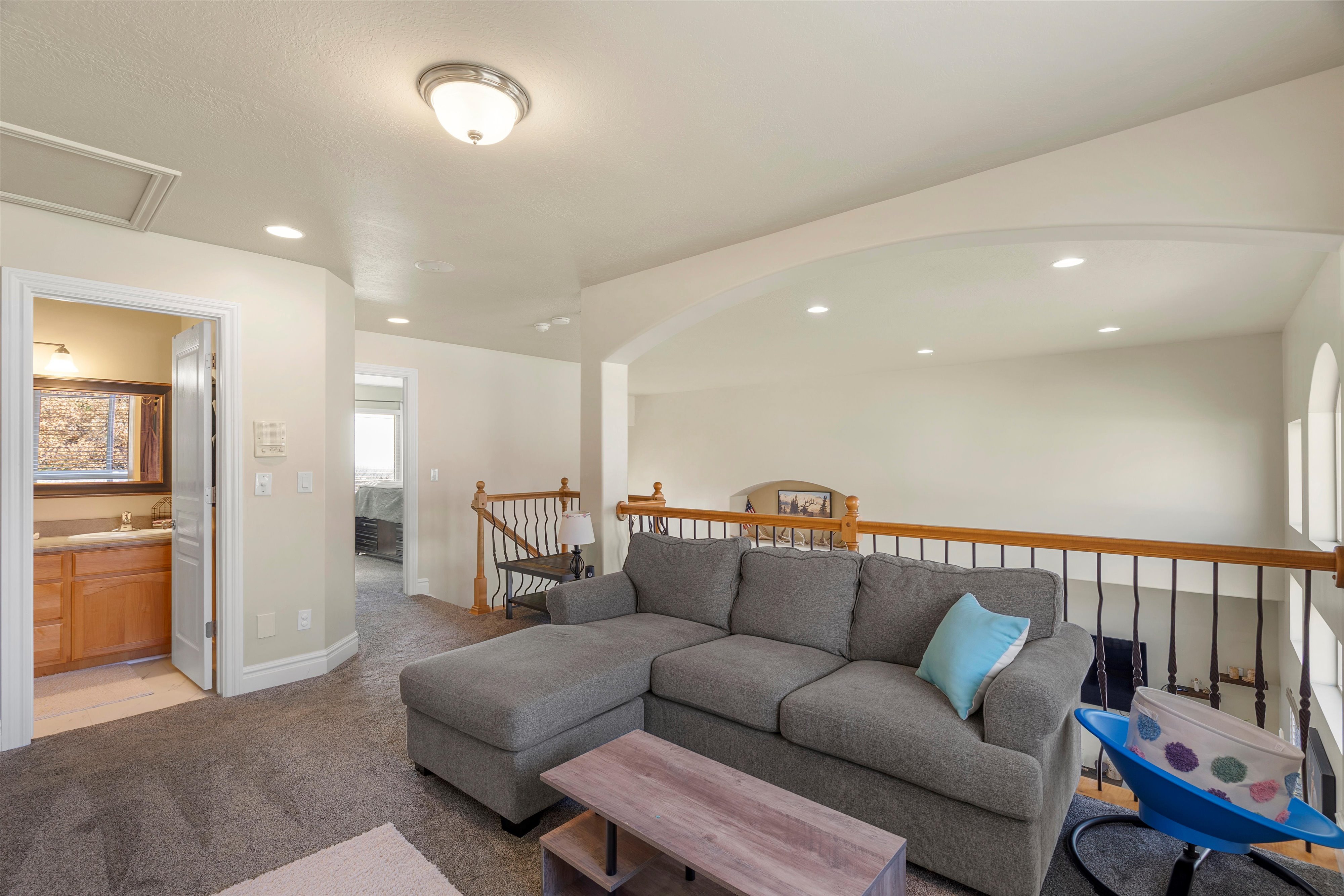 Living room with light carpet and recessed lighting