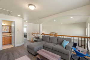 Living room with light carpet and recessed lighting