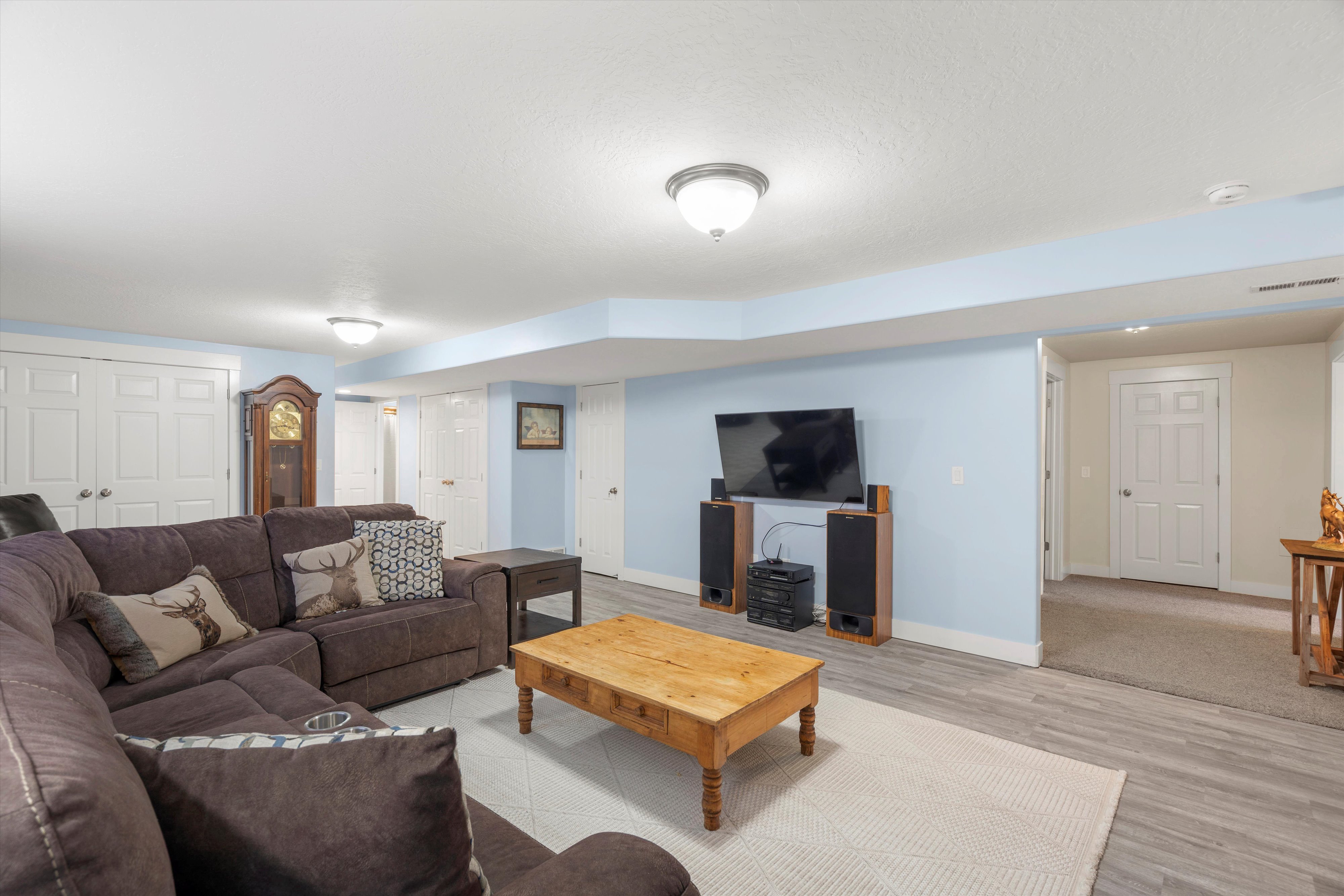 Living room with baseboards and light wood-style flooring