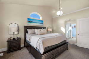 Bedroom featuring lofted ceiling, arched walkways, and carpet floors