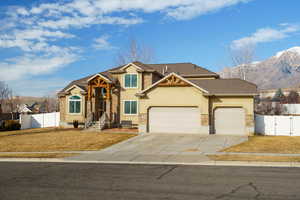 View of front of house featuring a garage, a gate, stucco siding, driveway, and a mountain view