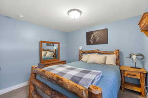 Carpeted bedroom featuring a textured ceiling