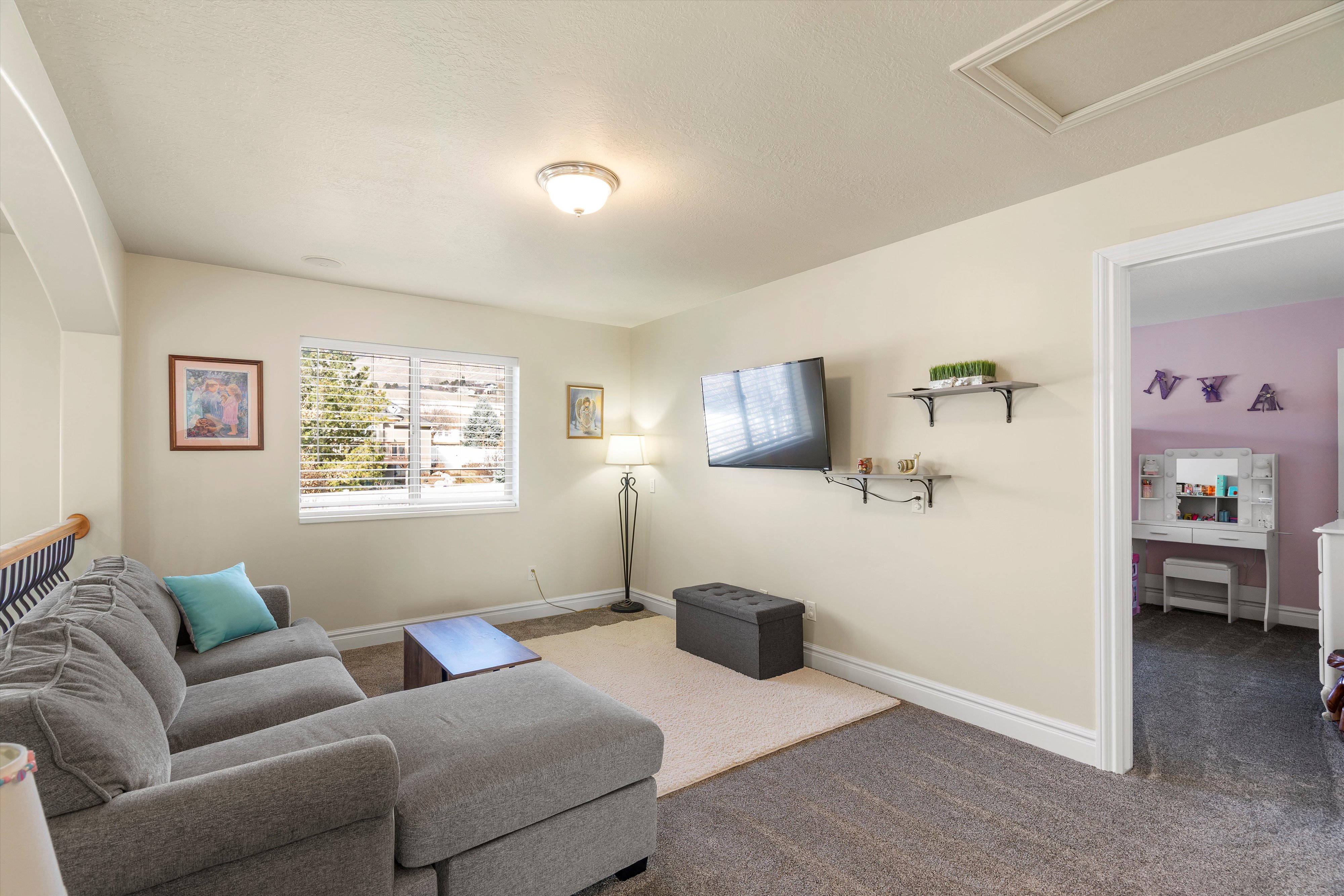 Living area with baseboards and carpet floors