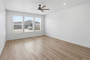 Empty room with a ceiling fan, light wood-style floors, a textured ceiling, and recessed lighting