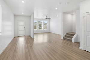 Entrance foyer with ceiling fan, light wood-type flooring, recessed lighting, and a textured ceiling