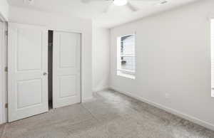 Unfurnished bedroom with a closet, light carpet, and ceiling fan
