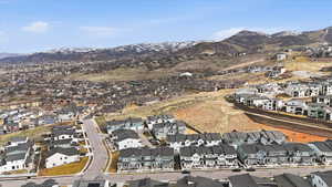 Aerial view of property's location featuring nearby suburban area and a mountain backdrop