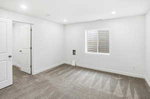 Unfurnished room with light colored carpet and recessed lighting