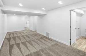 Finished basement featuring recessed lighting and light carpet