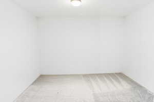Empty room with light colored carpet