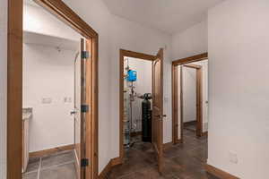 Great room looking towards staircase area, laundry room, utility closet, and storage room under the stairs