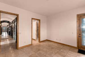 Unfurnished bedroom featuring plenty of natural light and arched walkways