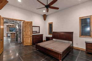 Primary Suite featuring ceiling fan, recessed lighting, and a textured wall