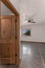 Hall looking into third bedroom featuring a textured ceiling and finished concrete floors