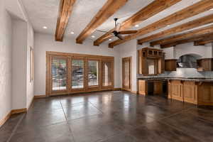 Kitchen with recessed lighting, beamed ceiling, tasteful backsplash, a ceiling fan, and glass insert cabinets