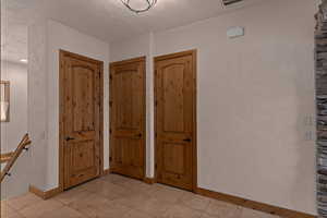 Garage foyer/mudroom entrance featuring baseboards and light tile patterned flooring