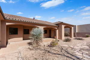 Rear view of property with stucco siding and a patio