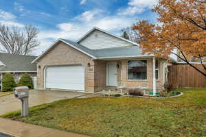 Ranch-style home featuring roof with shingles, an attached garage, a porch, concrete driveway, and brick siding