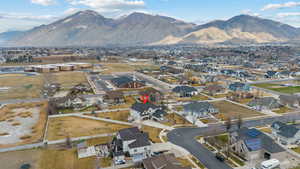 Aerial perspective of suburban area featuring a mountain backdrop