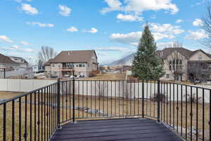 Wooden terrace featuring a residential view and a mountain view