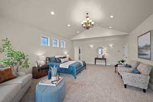 Bedroom with a chandelier, carpet, and lofted ceiling