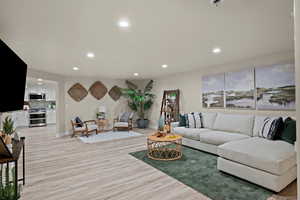 Living room featuring light wood-type flooring and recessed lighting